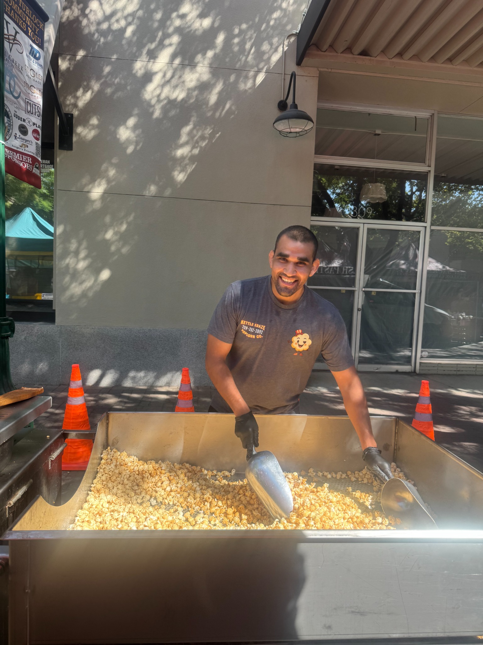 Chilo scooping freshly made kettle corn at a Kettle Kraze event